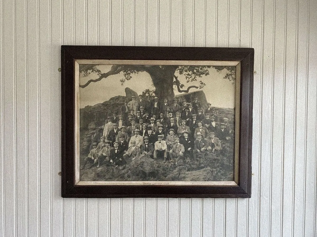 A framed historic photograph of a local community gathering