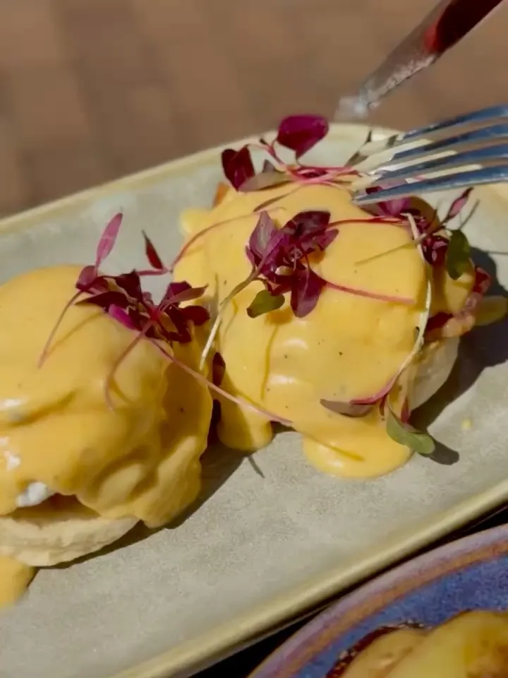 Eggs Benedict topped with hollandaise sauce
