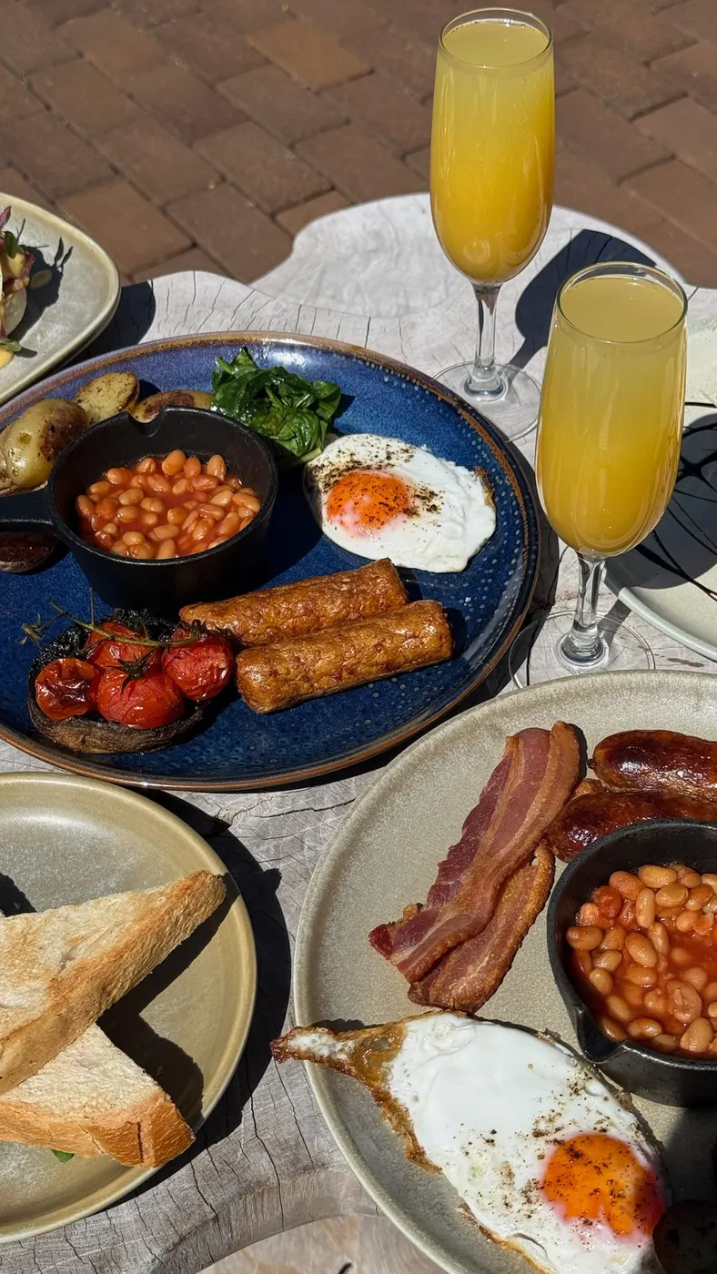 Full breakfast plates with toast and glasses of orange juice