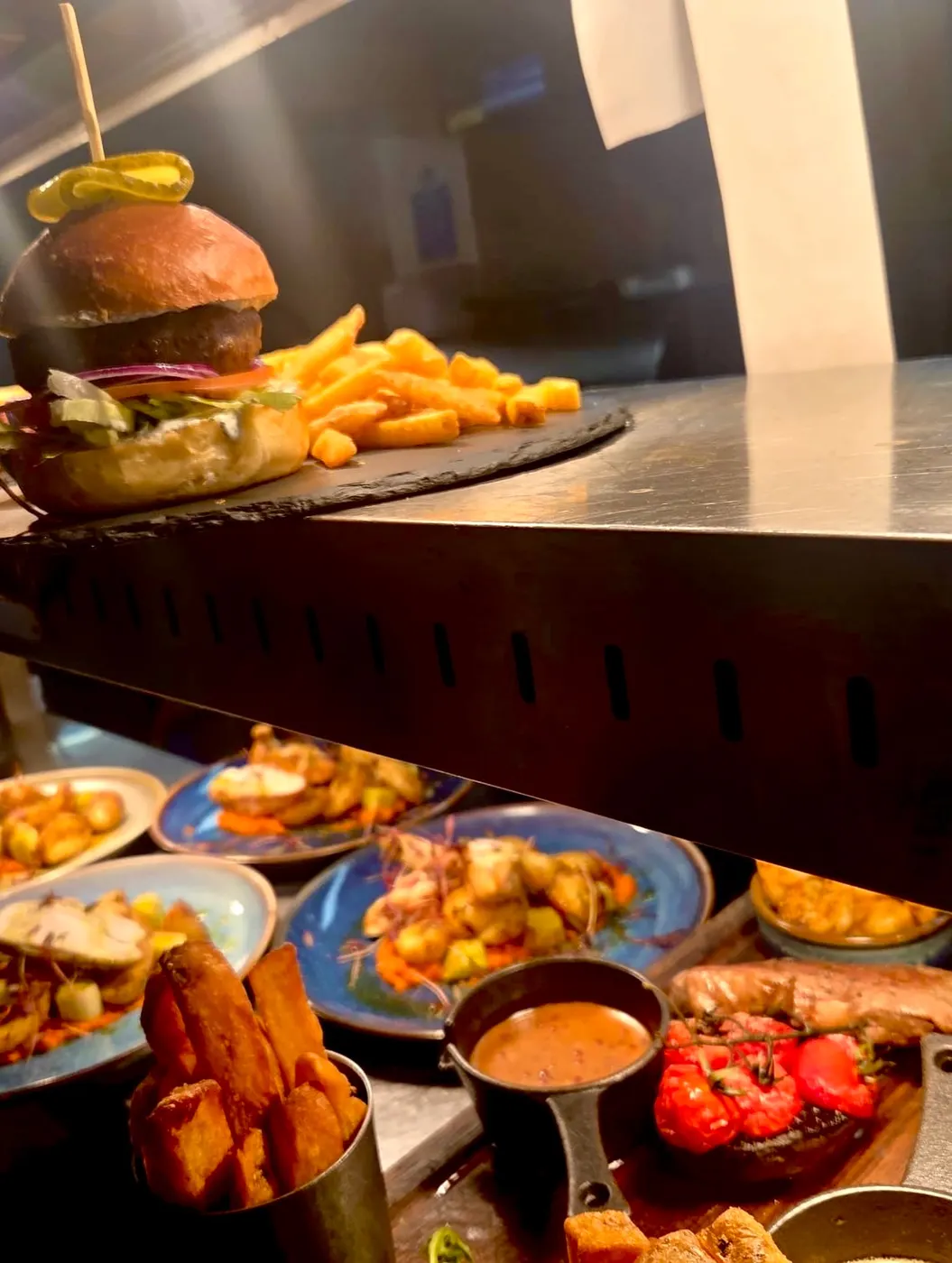 Burger in a toasted bun served with chips