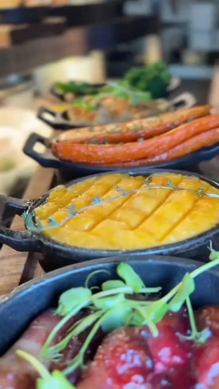 Pies and sausages served in individual skillets